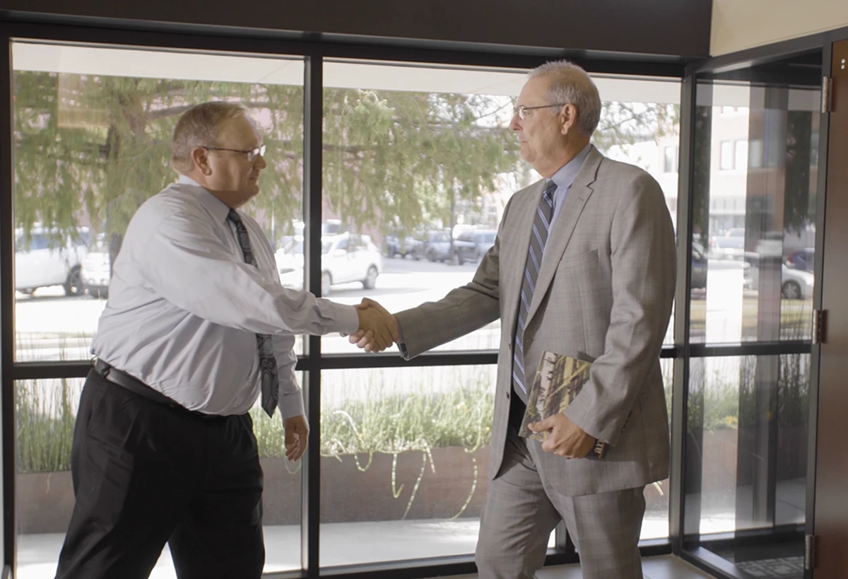 Caption: OCCF’s Joe Carter meets with donor Brett Ramsey of the Blue & Gold Sausage Company.